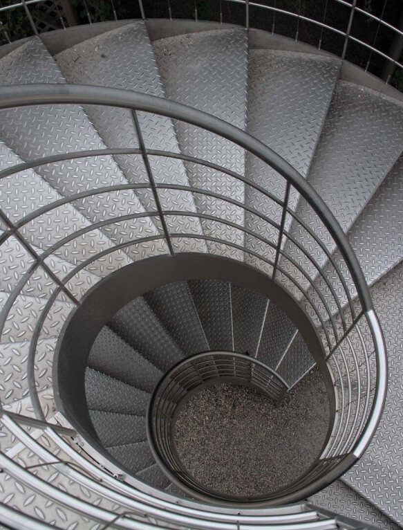 Spiral staircase with an aluminium handrail seen from above