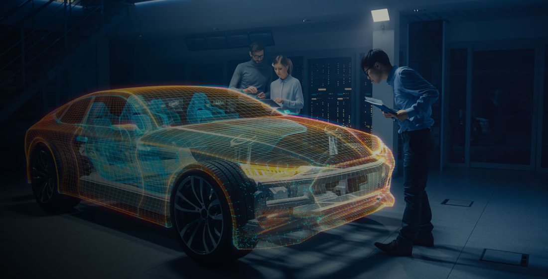 Engineers reviewing a wireframe car design