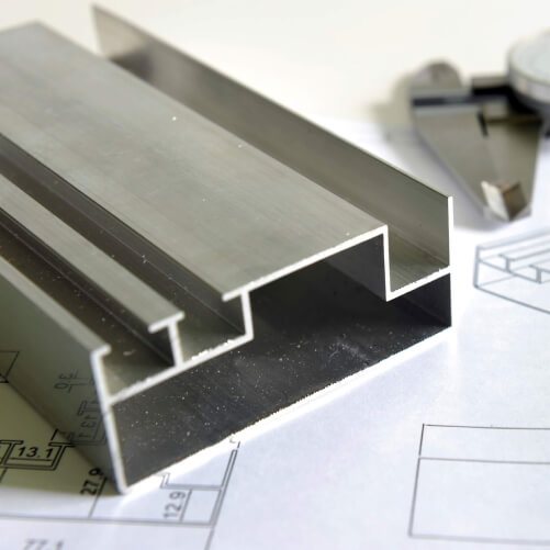 Cut and machined aluminium section on a drawing